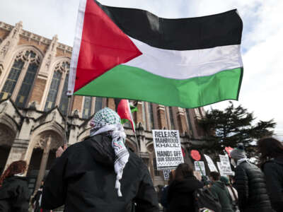 People hold signs and Palestinian flags as they protest the arrest of former Columbia University student activist Mahmoud Khalil and show support for Palestinians during a "Fight for Our Rights" demonstration by Shut It Down for Palestine (SID4P) and various local groups at the University of Washington campus in Seattle, Washington, on March 15, 2025.