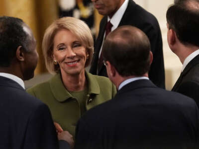 Then-Secretary of Education Betsy DeVos (2nd left) attends an East Room event at the White House on October 24, 2018, in Washington, D.C.
