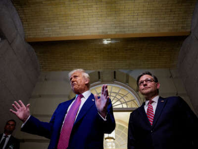 President Donald Trump, accompanied by Speaker of the House Mike Johnson (right), speaks to members of the media as he departs a House Republican meeting at the U.S. Capitol on May 20, 2025, in Washington, D.C.