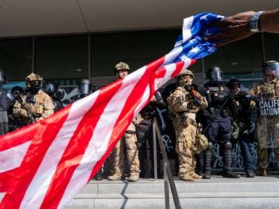 The National Guard and police confront protesters after a series of immigration raids on June 09, 2025, in Los Angeles, California.